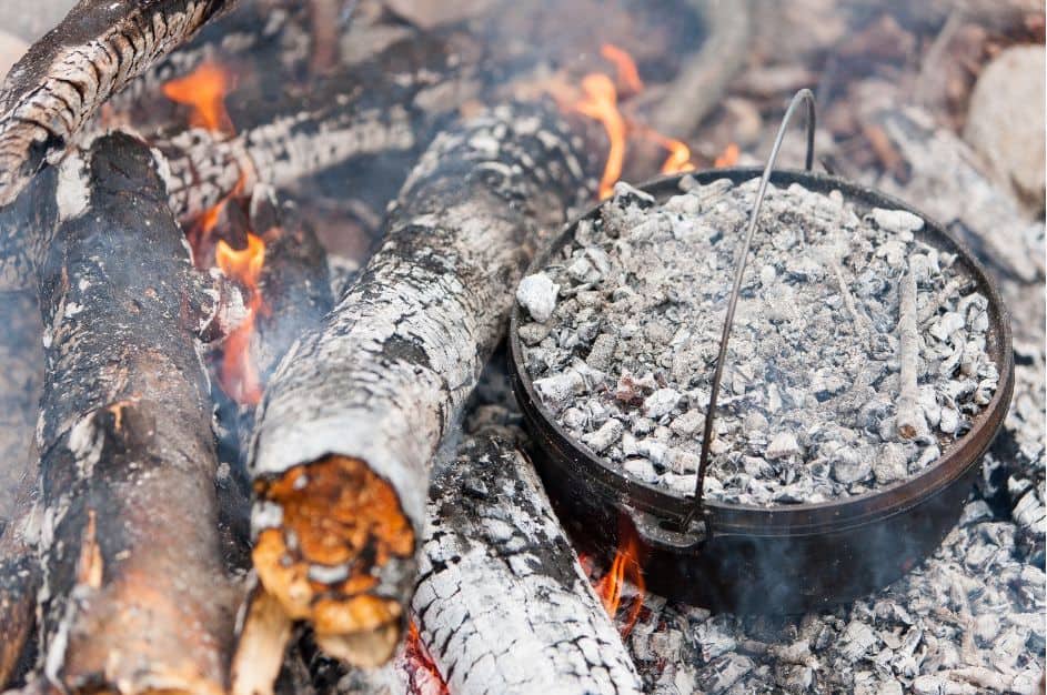 It's important to cover the Dutch oven with coals as well so the top part of the dessert cooks evenly.