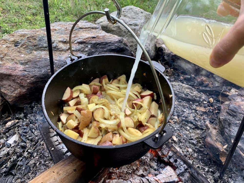 Chicken broth is poured into the pan and brought to a boil.