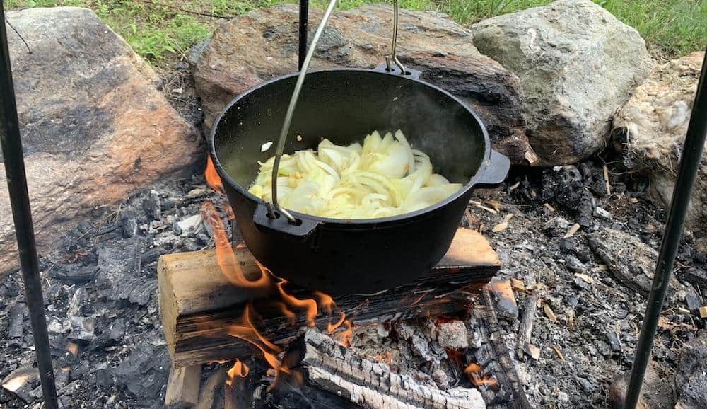 Sliced onions are added to the pot and sauteed until wilted.