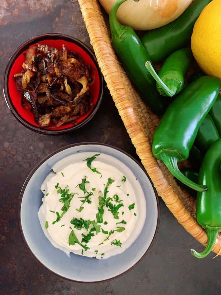 Sides for mujadara include yogurt and crispy onions. They await the complete dish.
