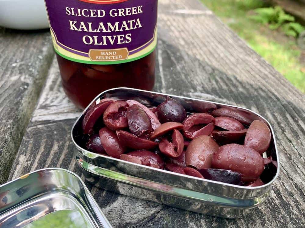 One half cup of sliced kalamata olives are ready to use in the recipe.