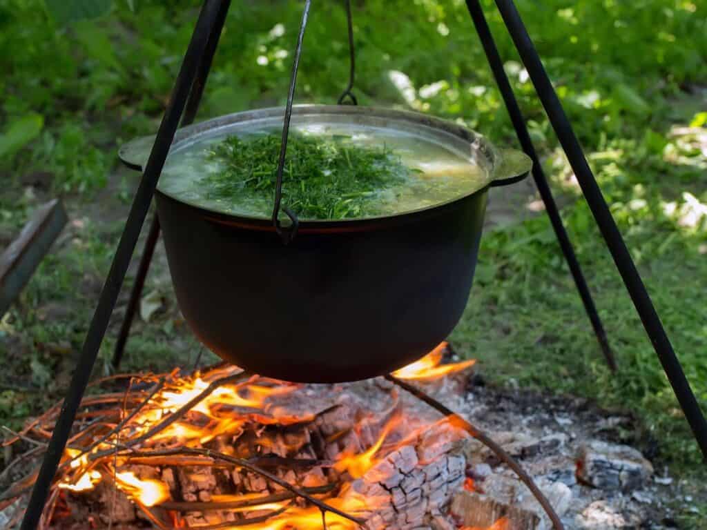 Cooking with a camping tripod over the fire is a really fun way to create added atmosphere when outdoors.