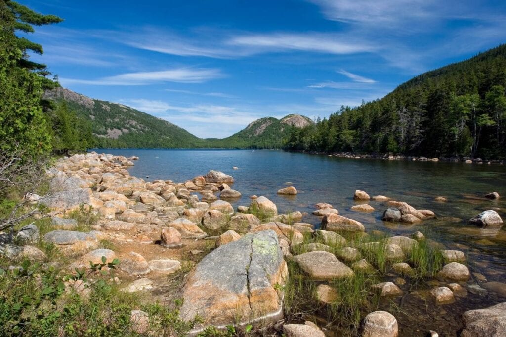 The Jordan Pond trail has a serene view with Bubble Mountains in the distance.