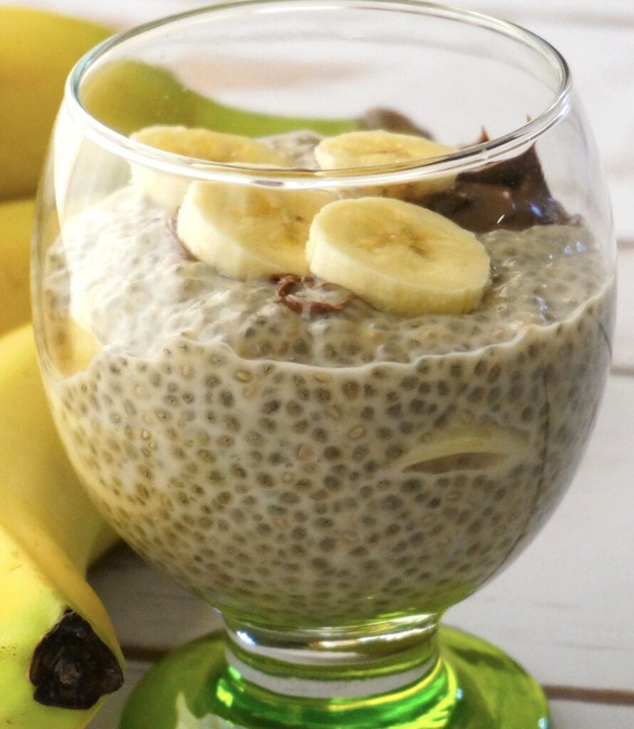 A scrumptious jar of chia seed pudding topped with fresh bananas, perfect for make-ahead breakfasts for camping.