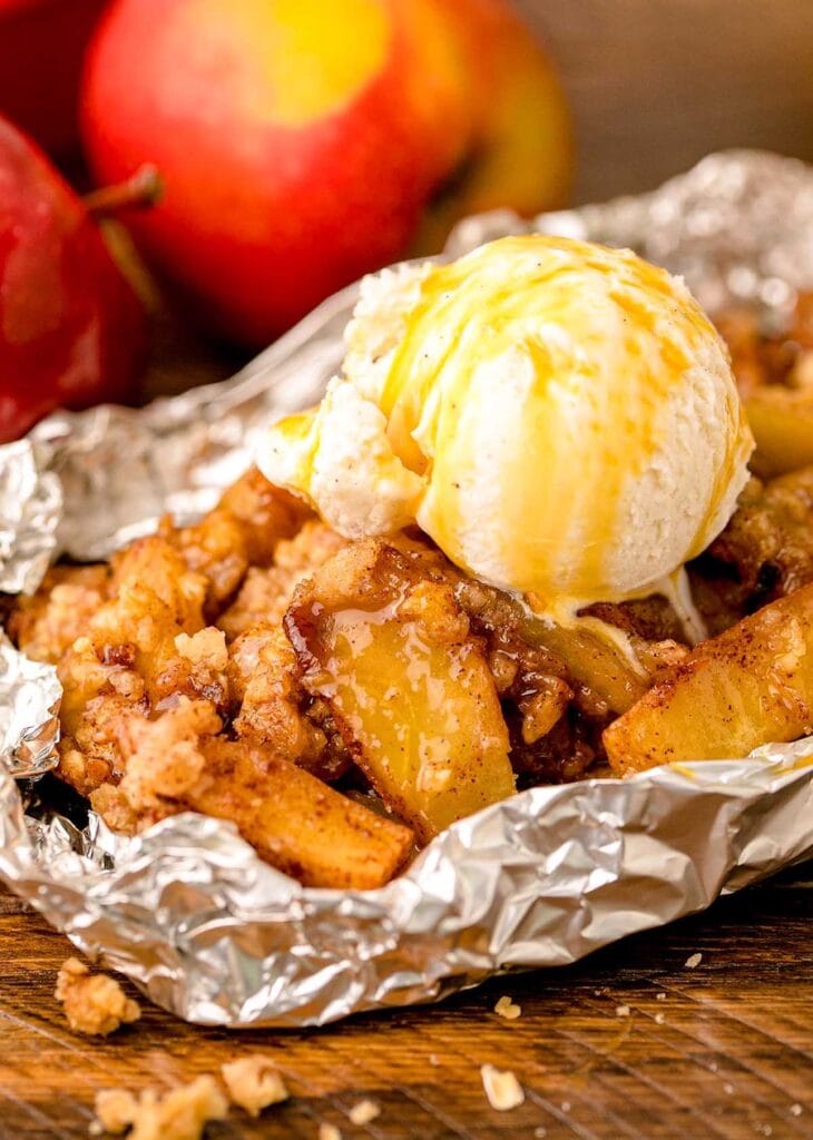 This campfire apple crisp gets all caramelized in the foil packets over the fire and has to be served with a big scoop of vanilla ice cream on top!