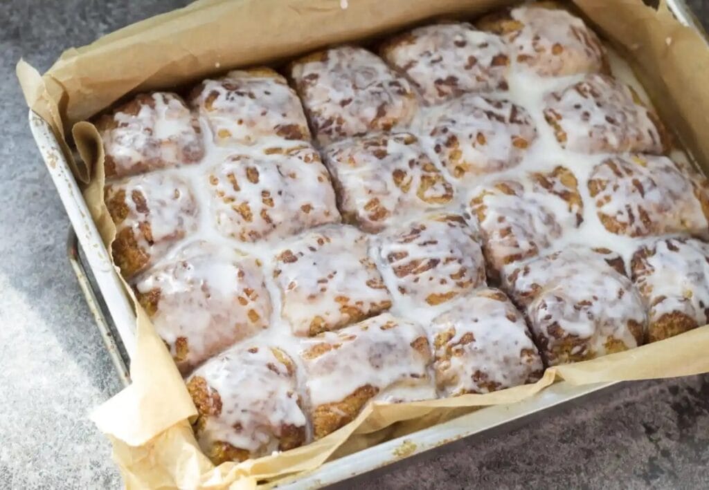 These gold brown pull apart cinnamon bread pieces look tantalizing with white icing on top.