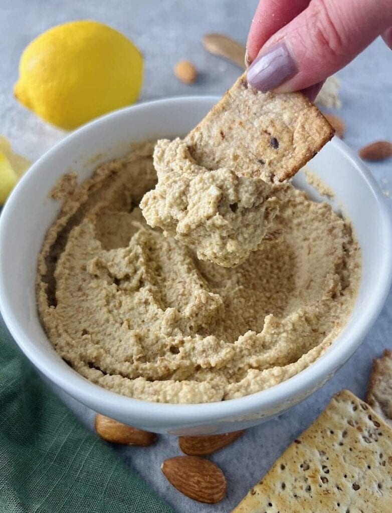 Creamy almond dip is a perfect pair with crunchy crackers for a camping snack idea.