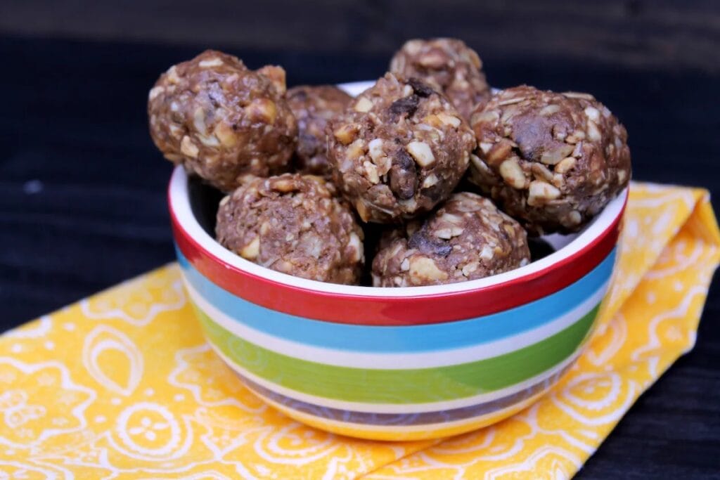These chunky energy bites sit in striped bowl waiting for snacking.