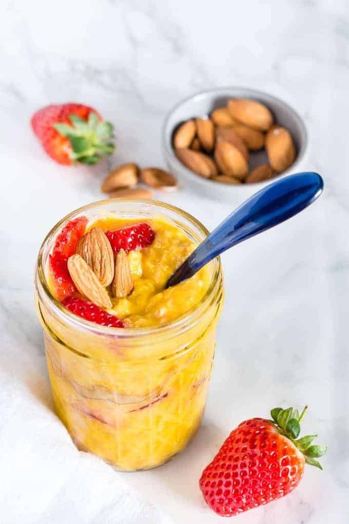 The color of these mango overnight oats is golden yellow. Topped with strawberries and almost it is quite a beautiful jar of goodness!