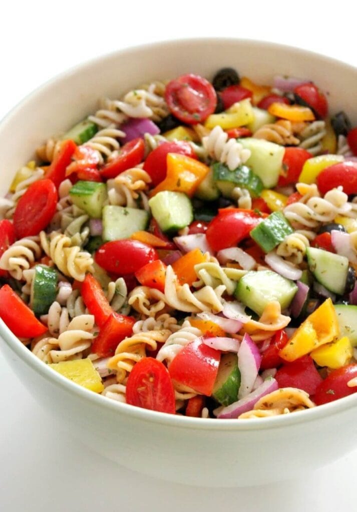 This bright and cheery pasta salad has chopped cucumber, tomatoes, and red pepper in it.
