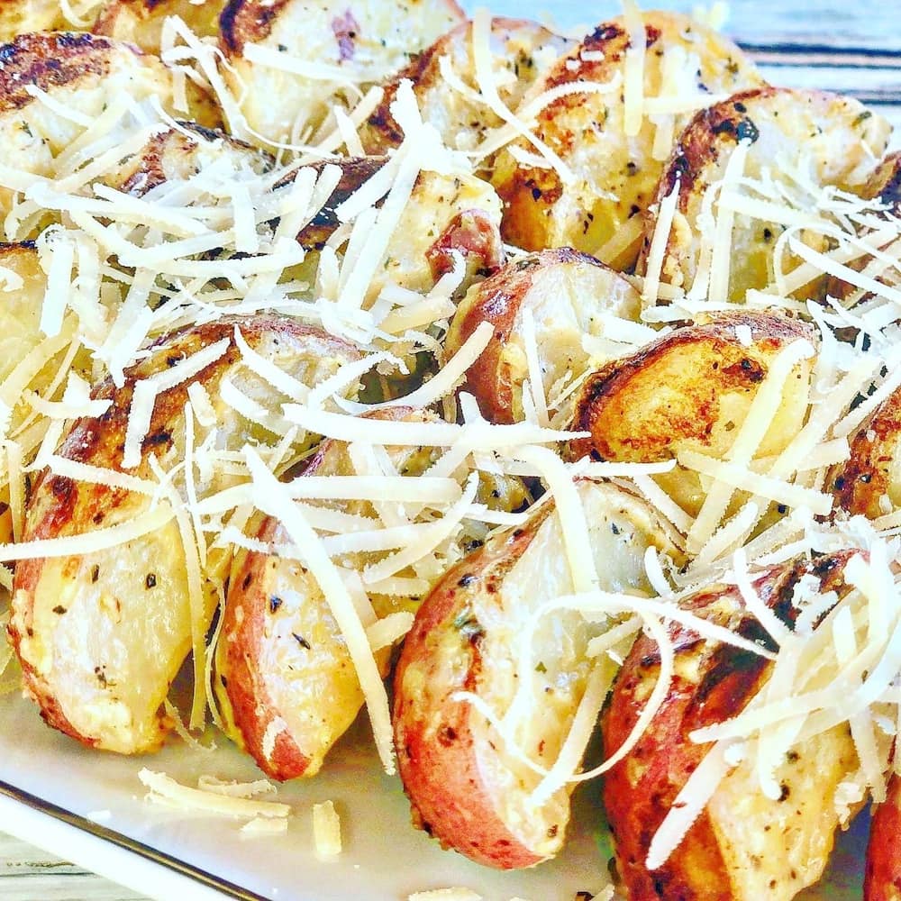 These golden potato skewers are topped with shredded cheese and look very inviting.