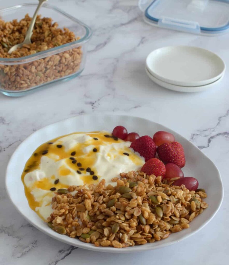 This bowl of puffed rice granola looks very inviting with a side of yogurt and strawberries.