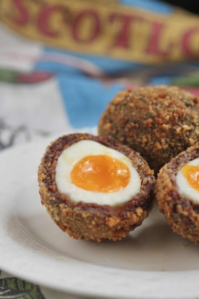A delectable assortment of golden-brown scotch eggs, a savory and protein-packed make-ahead breakfast for camping trips.