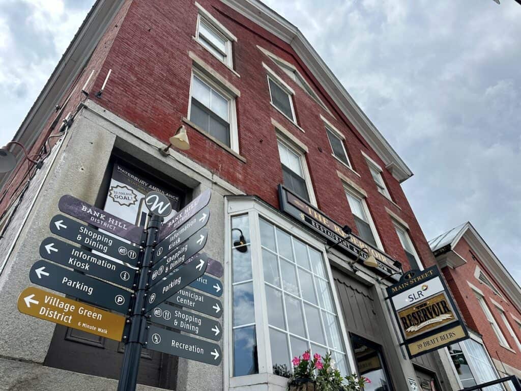 Downtown Waterbury is both quaint and picturesque. The Reservoir Tap and Grill sits at the center of the intersection of Main Street and Stowe Street. Signs direct visitors to places of interest.
