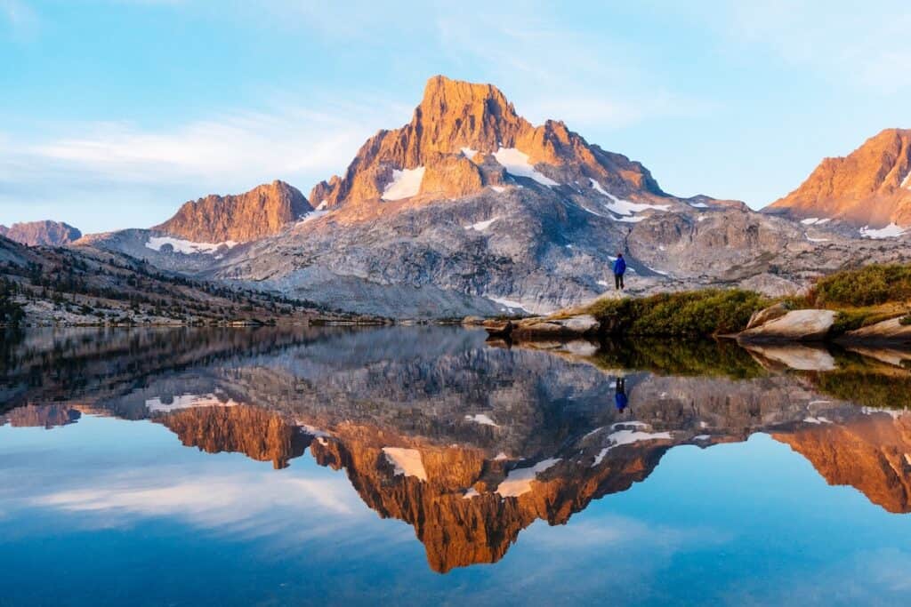Thousand Islands Lake is epically beautiful and the reflection of the rocky gray and orange-hued mountain in the lake is crystal clear. 
